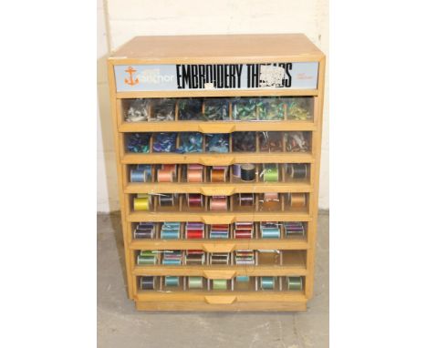 Vintage wooden 'Anchor' shop cabinet, with seven glass-fronted drawers, containing wide range of embroidery silks and sewing 