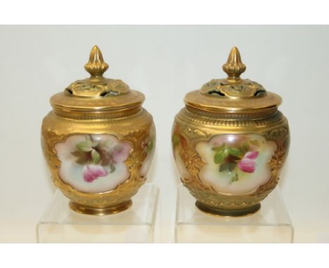 Pair of Royal Worcester pot pourri vases and covers, hand decorated with pink roses on a blush ground. Printed marks to base,