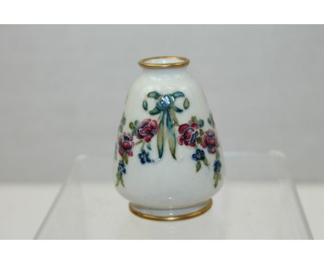 Moorcroft MacIntyre enamel vase with floral decoration on white ground - printed marks and green painted signature to base, 7