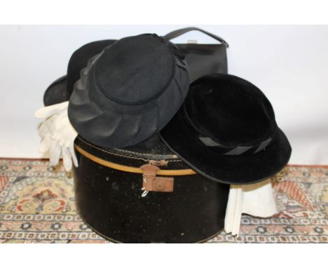 Vintage circular hat box containing ladies' 1950s black hat and one other, gentlemen's bowler hat, small black leather handba