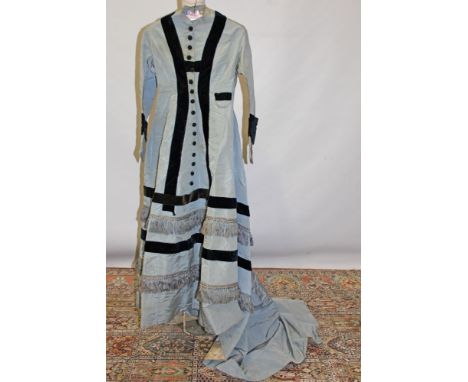 Victorian pale blue silk dress with navy blue velvet ribbon trims and silk tassel trims, covered button-through front fasteni