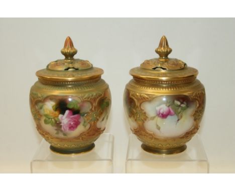 Pair of Royal Worcester pot pourri vases and covers, hand decorated with pink roses on a blush ground. Printed marks to base,