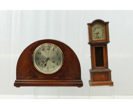 Edwardian dome-top mantel clock with silvered dial in inlaid case (pendulum present) and a miniature longcase clock in mahoga