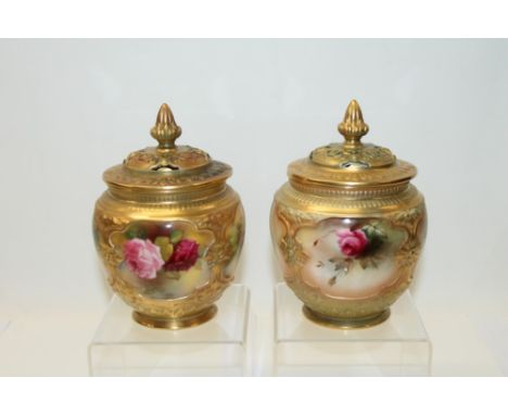 Pair of Royal Worcester pot pourri vases and covers, hand decorated with pink roses on a blush ground. Printed marks to base,