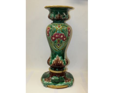 Late 19th / early 20th century Majolica jardinière stand, with floral Art Nouveau influenced decoration on green ground, 74cm