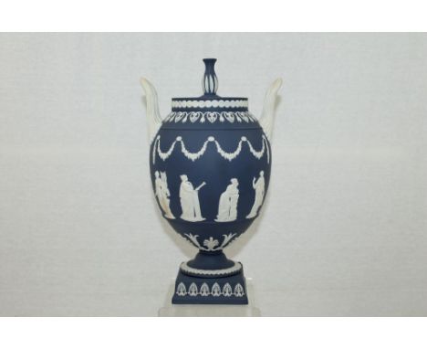 Wedgwood Jasper ware navy blue and white two-handled urn with cover, on plinth square base - depicting neoclassical figures, 