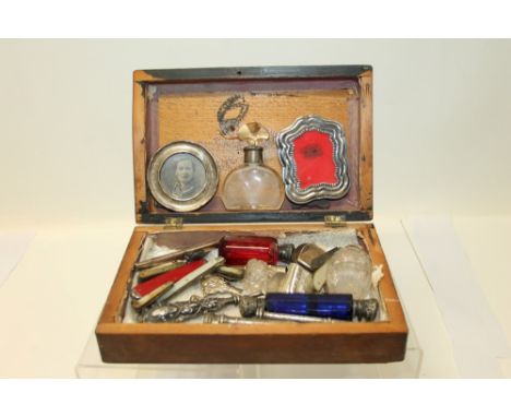 Wooden box containing a selection of miscellaneous silver and white metal - including silver mounted scent bottles, propellin