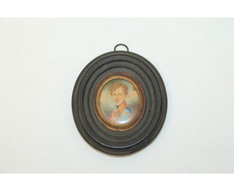 Early 19th century miniature head and shoulders image of an army officer, with gilt metal surround, in an ebonised oval frame
