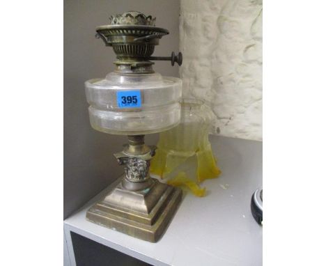 A Victorian Hinks brass oil lamp with clear cut glass reservoir and a Victorian floral etched glass shade, ranging from yello