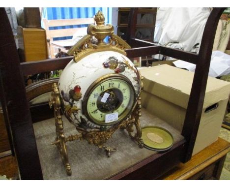 A Victorian circular ceramic mantle clock decorated with foliage, stand on ormolu mounts 