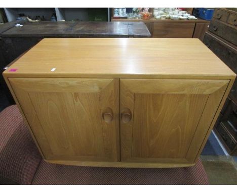 A retro light oak Ercol side cabinet, twin doors with single internal shelf, design number 1013, 26 6/8" x 36" x 17 2/8" 