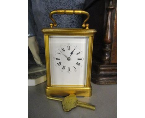 A brass cased carriage clock having white enamel dial, Roman numerals and bevelled glass, 5 1/2"h 