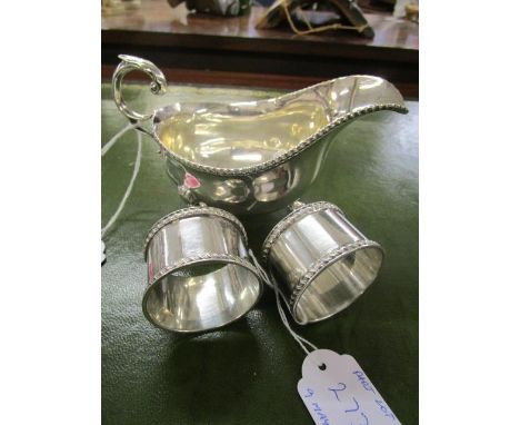 An early 20th century silver sauce boat with reeded edge, three cast feet, rococo c-scrolled handle, Sheffield 1923, makers i