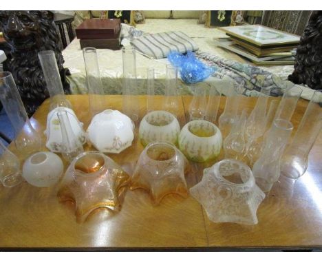 A selection of Victorian etched glass oil lamp shades, painted opal glass light shades and various smoke funnels 