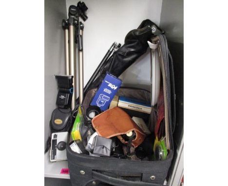 A camera tripod, light metres and accessories 