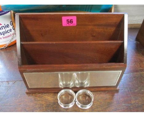 An Asprey & Garrard mahogany letter rack with silver reeded front panel and a pair of napkin rings 