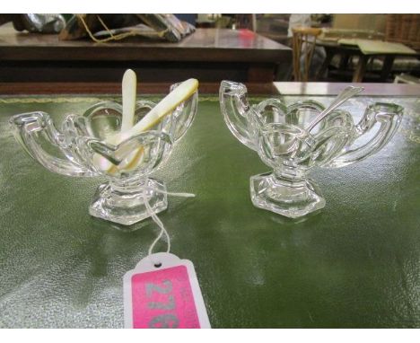 A pair of 1930s Chippendale glass salts with two mother of pearl salt spoons and a pair of silver salt spoons 
