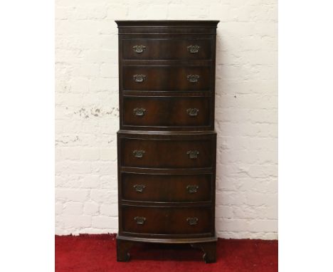 A mahogany bowfronted six high chest of drawers raised on bracket feet.