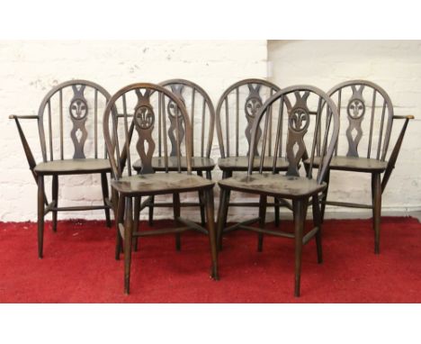 A set of four and two carved Ercol dining chairs with Prince of Wales feather back.