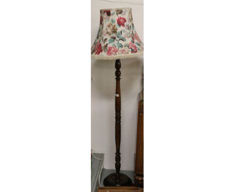 A turned oak standard lamp and shade.