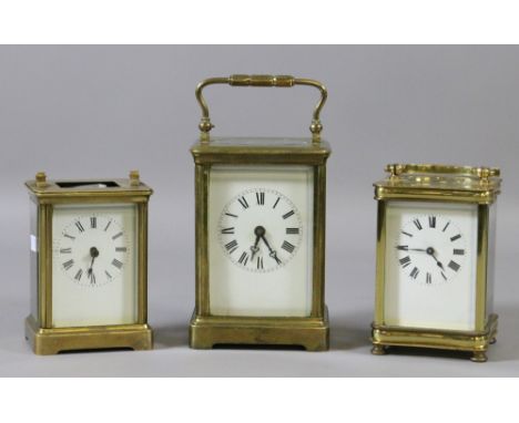 Three brass cased eight day carriage clocks each with enamel faces.
