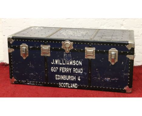 A metal bound students travel trunk with inner storage tray.
