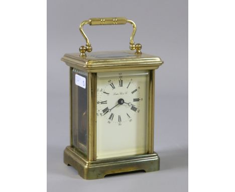 A 20th century brass cased carriage clock with enamel face by London Clock Company.