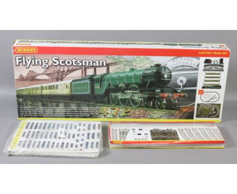 A Hornby boxed OO gauge flying Scotsman train set, additional track and a model railway book.