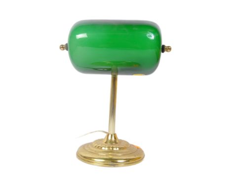 A vintage 20th Century bankers office table lamp light. Having a green glass swinging shade, with brass reeded support on a s
