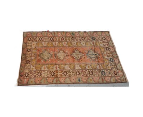 An early 20th Century Persian floor carpet rug. Central red panel with repeating cream &amp; red borders decorated with geome