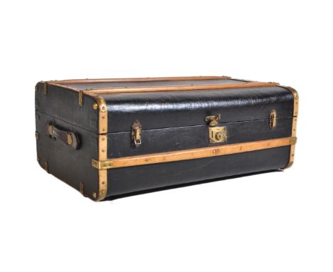 A vintage early 20th century steamer travel trunk suitcase. Black canvas body&nbsp; having wooden bound bentwood strapwork to