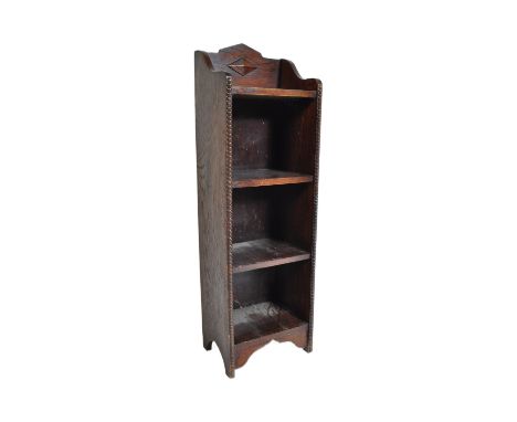 A 1920's Jacobean revival solid oak upright small open window bookcase. The bookcase with beaded leading edges, the top shelf