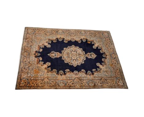 A large early 20th Century Persian floor carpet rug. Ivory ground with central medallion surrounded by repeating patterns and