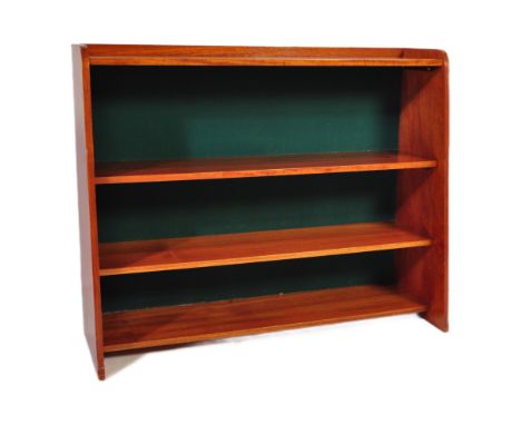 A mid-century teak wood open window bookcase cabinet. The fixed central shelves raised on tapering end supports, the top shel