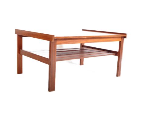 A vintage retro mid 20th Century teak coffee table. Of rectangular form with raised on sides, with under tier slatted magazin