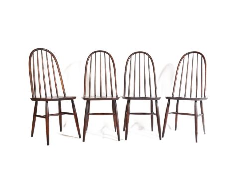 A set of four Ercol Quaker beech and elm dining Windsor chairs. Having a curved tall spindle backrest, square seats with circ