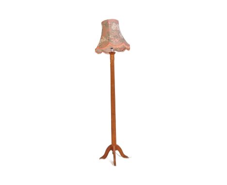 An early 20th century Arts and Crafts oak floor standing standard lamp. The lamp having medieval manner strap hinge decoratio