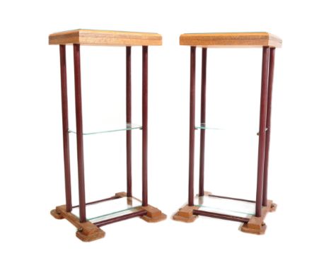 A pair of mid-century oak and tubular metal pedestal plant / bust stands. Each with oak tiers having tubular metal upright su