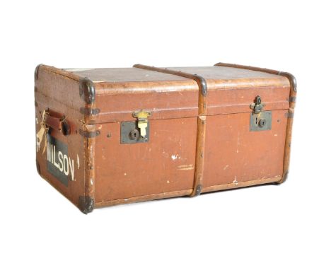 A retro vintage mid 20th century steamer travel trunk in brown colourway with metal mounts and wooden bentwood. Measures 40cm