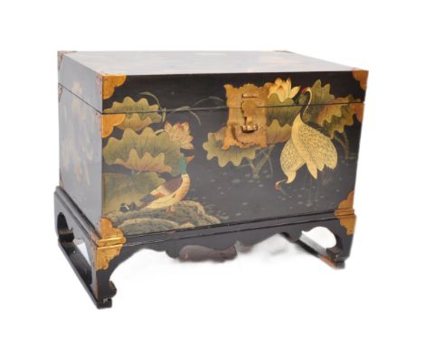 A vintage 20th Century Chinoiseries ebonised lacquered castle chest trunk box. With brass mounts, and lock, hinged lid openin
