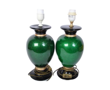 A pair of vintage 20th century ceramic lamp bases. Each base having a flared neck over a bulbous body in a green colourway wi