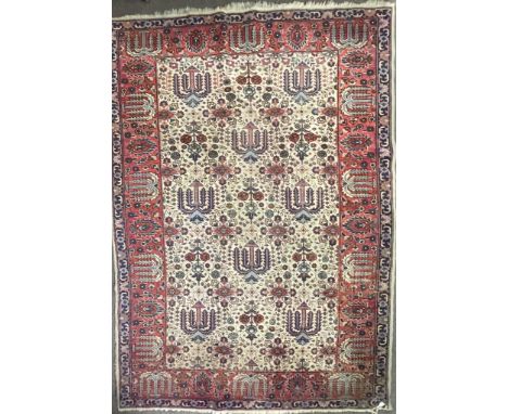 An early 20th century Persian Iran Djoscheghan floor carpet rug having repeating foliate patterns throughout with floral deco