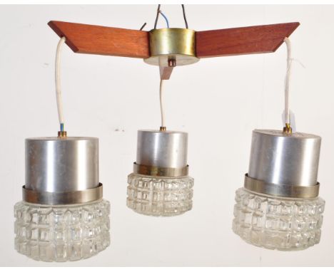 A retro mid 20th Century Danish inspired propeller ceiling light chandelier having three teak arms each with hanging textured