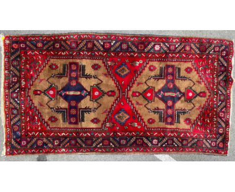 A vintage mid 20th century Persian Islamic Hamadan style rug carpet having a thick wall pile with two central medallions with