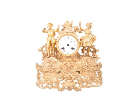 An early 20th century French gilded metal mantel clock having male and female musicians either side of the clock face, on an 