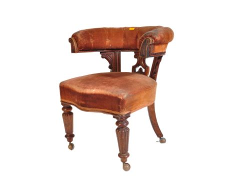 A 19th century late Victorian mahogany horse shoe shaped library desk chair in the manner of Gillows. The chair having bowed 