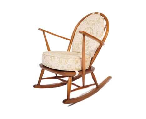 Ercol - Lucian Ercolani - A retro vintage mid 20th century blonde Windsor rocking chair having a hooped backrest, shaped elbo