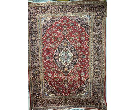 A large 20th century Central Persian Islamic Kashan floor rug carpet having a central cobalt, light blue &amp; white medallio