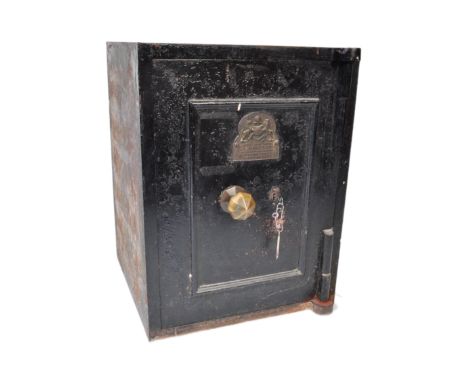 A Victorian late 19th century John Port of Manchester black cast iron safe with key. The safe having an official plaque to fr