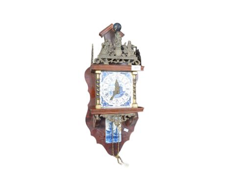 A vintage 20th century Dutch wall clock having delft tile clock face with roman numeral to chapter ring and windmill to centr